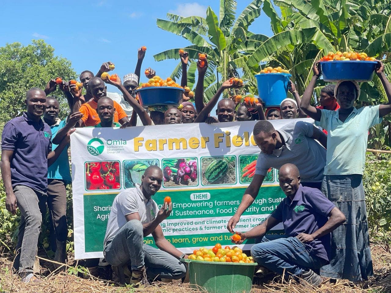 Smallholder farmers celebrating a harvest at a portfolio enterprise field day