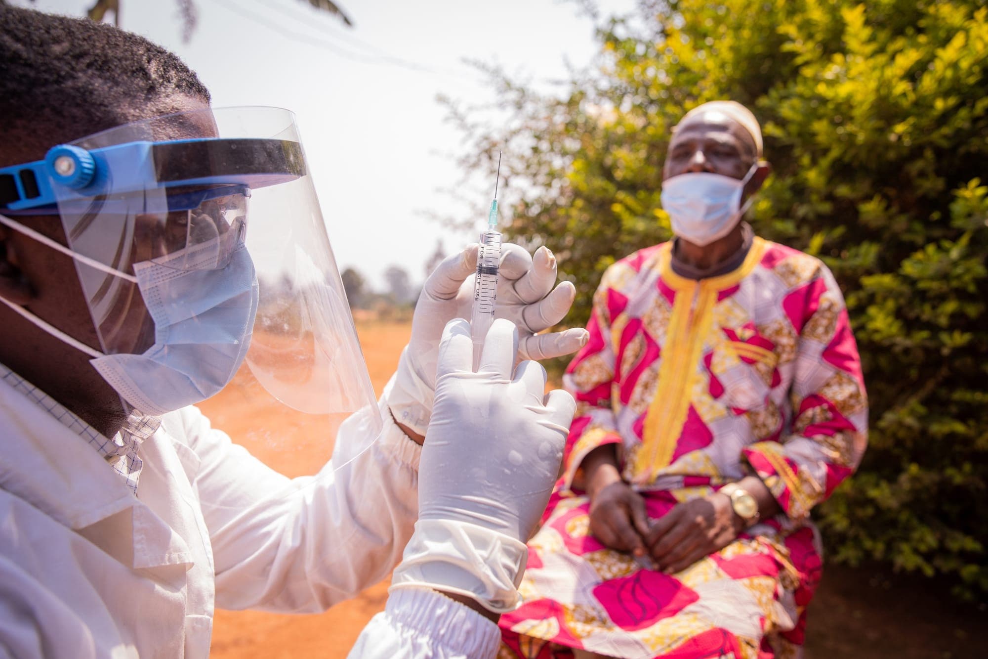 A health worker preparing a vaccination for a patient